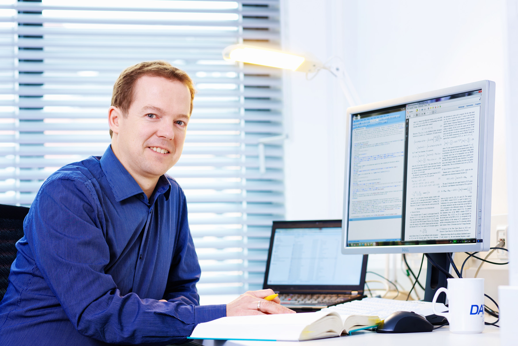portrait of group leader Dr. Meik Dörpinghaus, sitting next to his desk